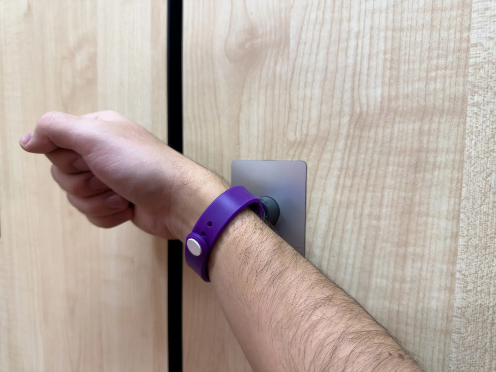 Athlete using wristband at the gym for medical ID and locker access