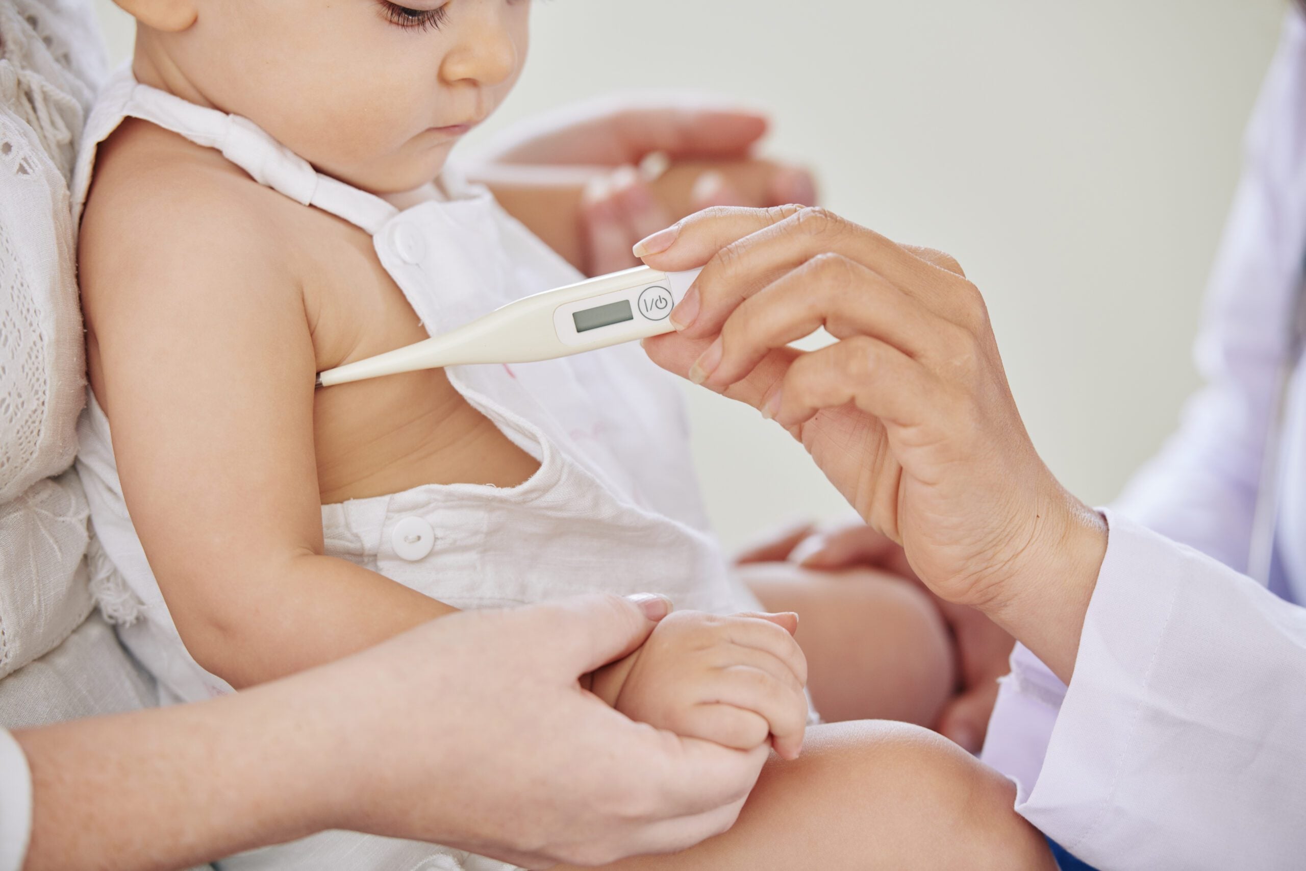 Checking temperature of baby girl