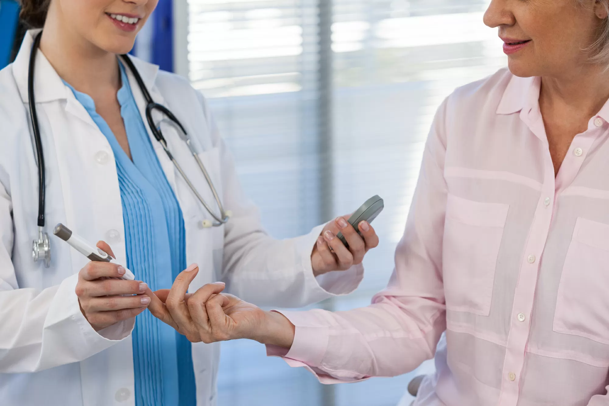 Doctor checking glucose level in a diabetic patient — Ozempic and GLP-1 safety