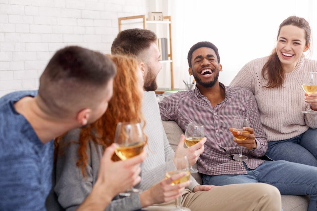 Friends drinking wine — alcohol can trigger epileptic seizures, wear a Mediband ID