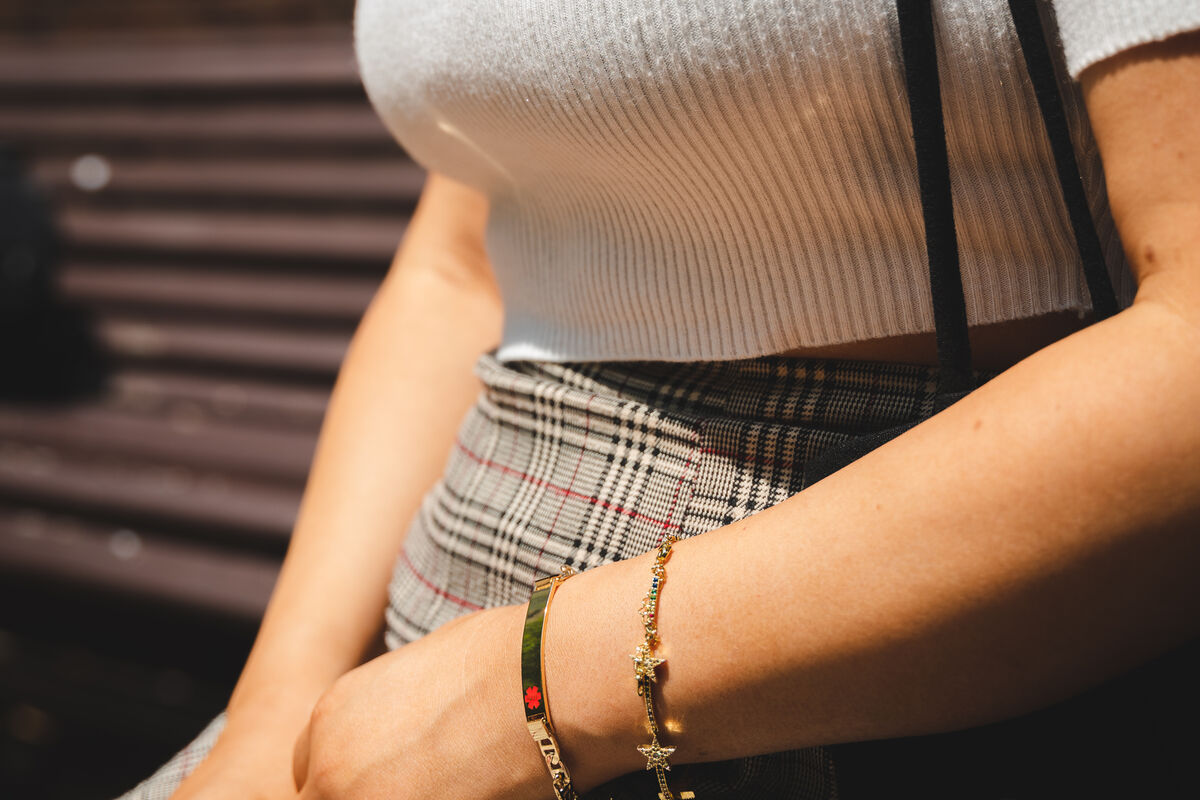 Woman wearing a gold engraved Mediband medical ID bracelet