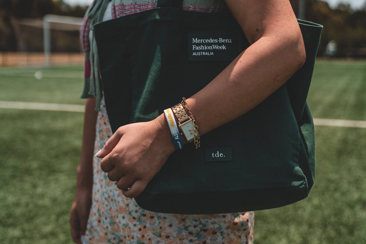 Close-up of a student's wrist wearing a Mediband on the school sports field