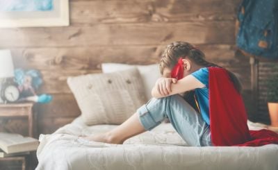 Young child in superhero costume — every autistic child deserves a safety net