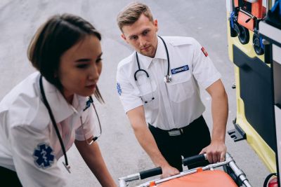 EMS first responder running with stretcher — medical alert bracelets save lives in emergencies