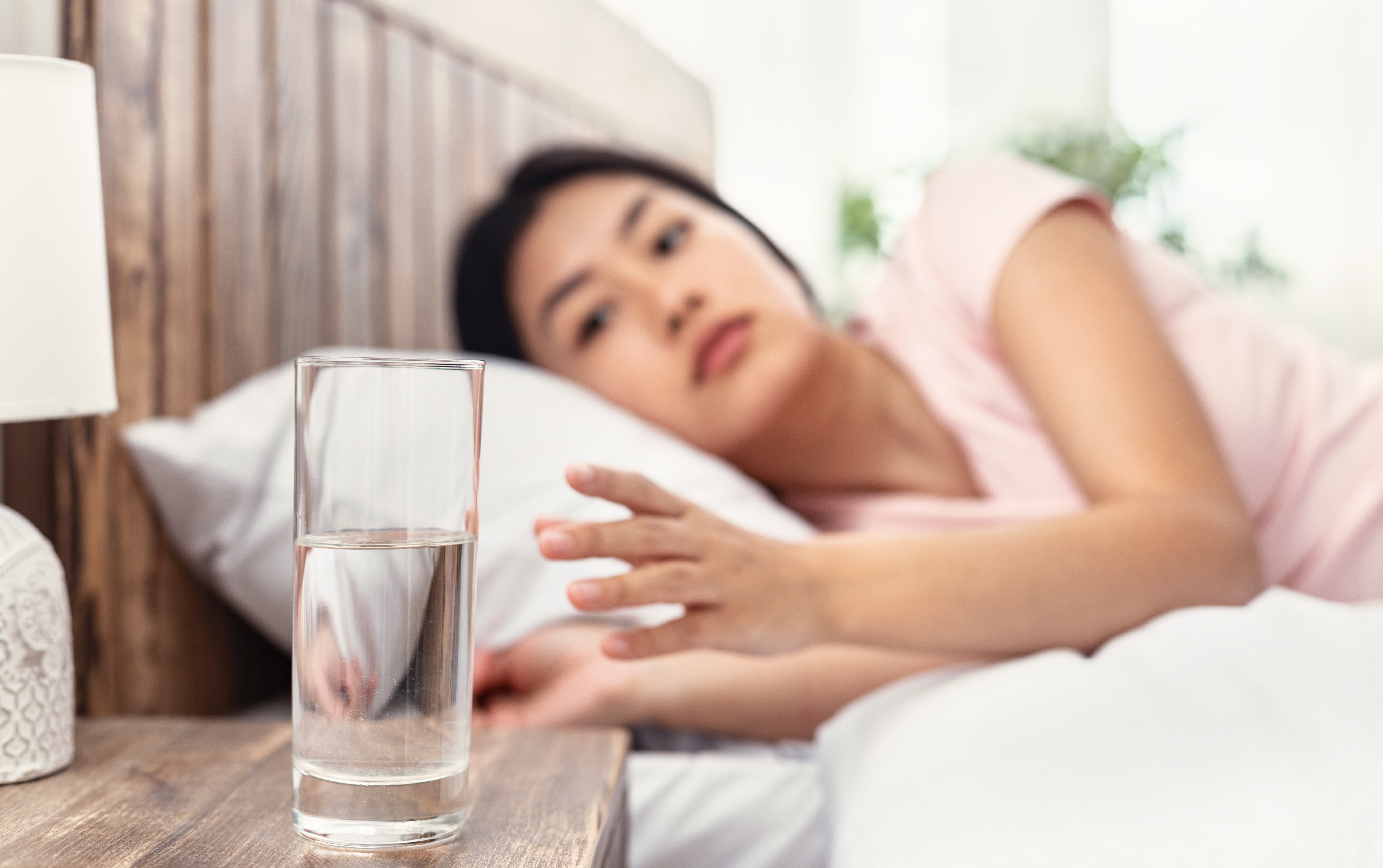 Woman drinking water in the morning — hydration and morning sunlight for natural energy