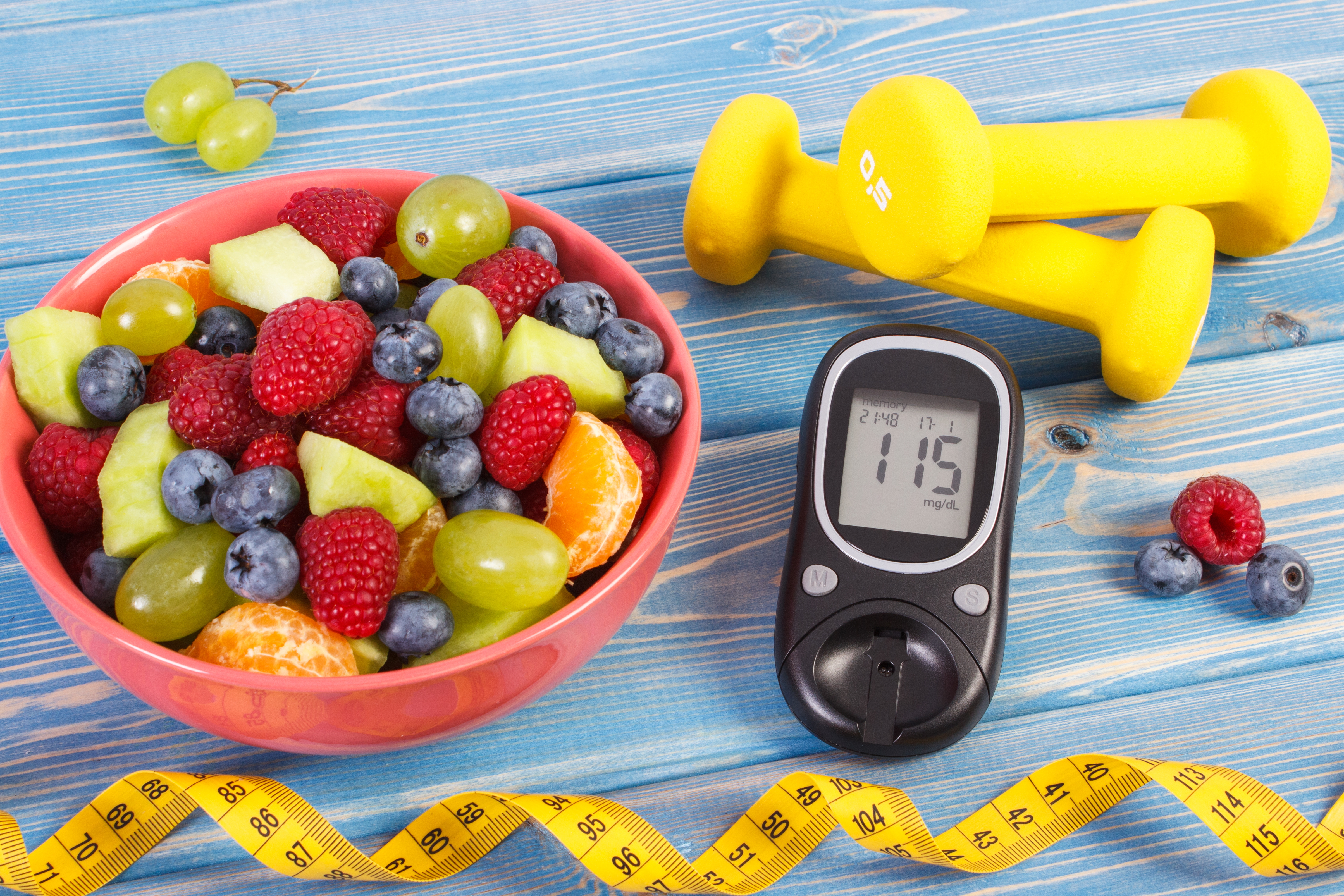 Fresh fruit salad with glucometer — healthy eating for managing chronic conditions