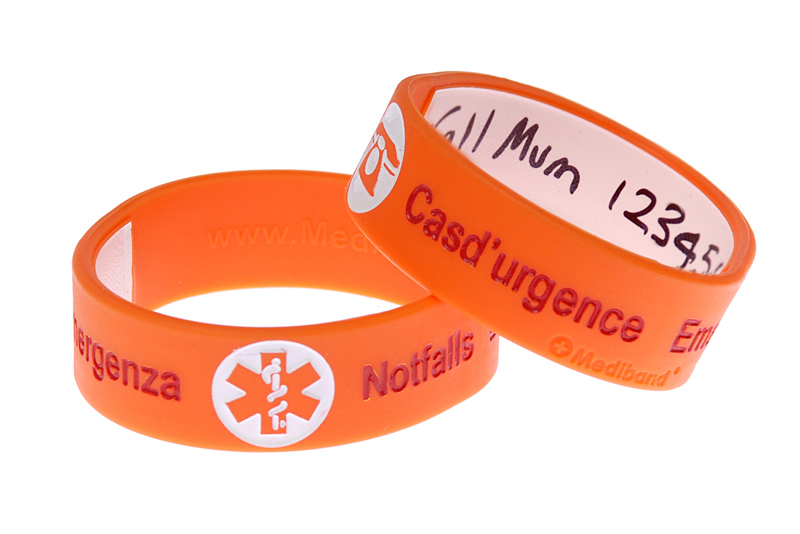 Child wearing orange write-on travel ID bracelet for safe travel with kids