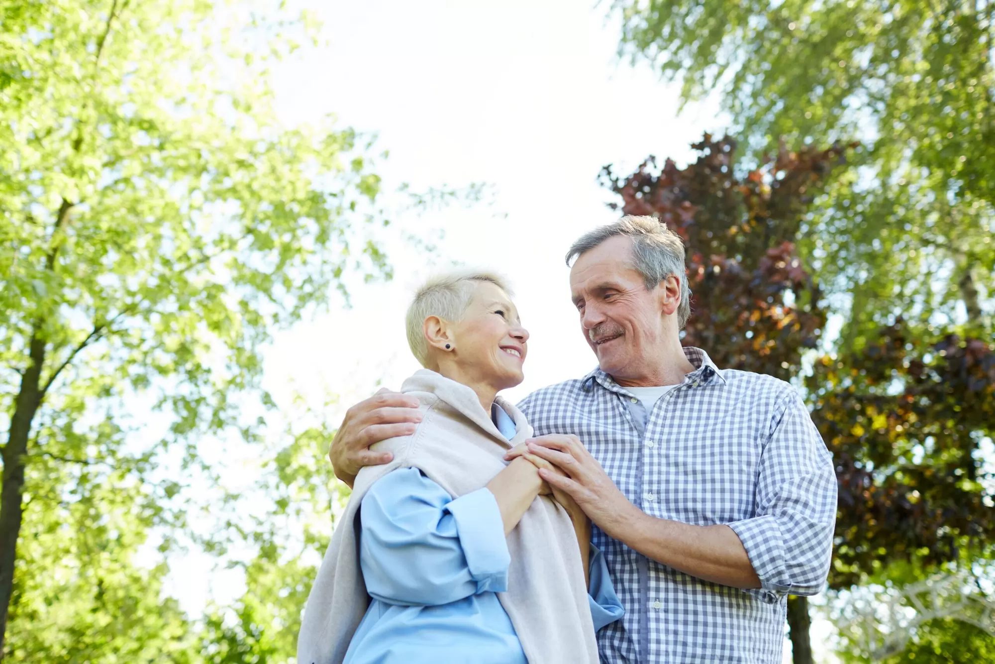 Senior couple walking in the park — coping well with chronic illness