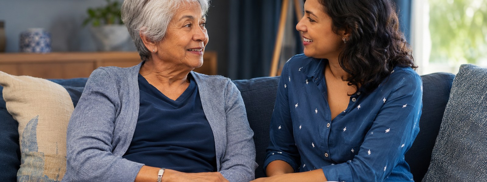 An older adult at home with her daughter, wearing a stainless steel medical alert bracelet